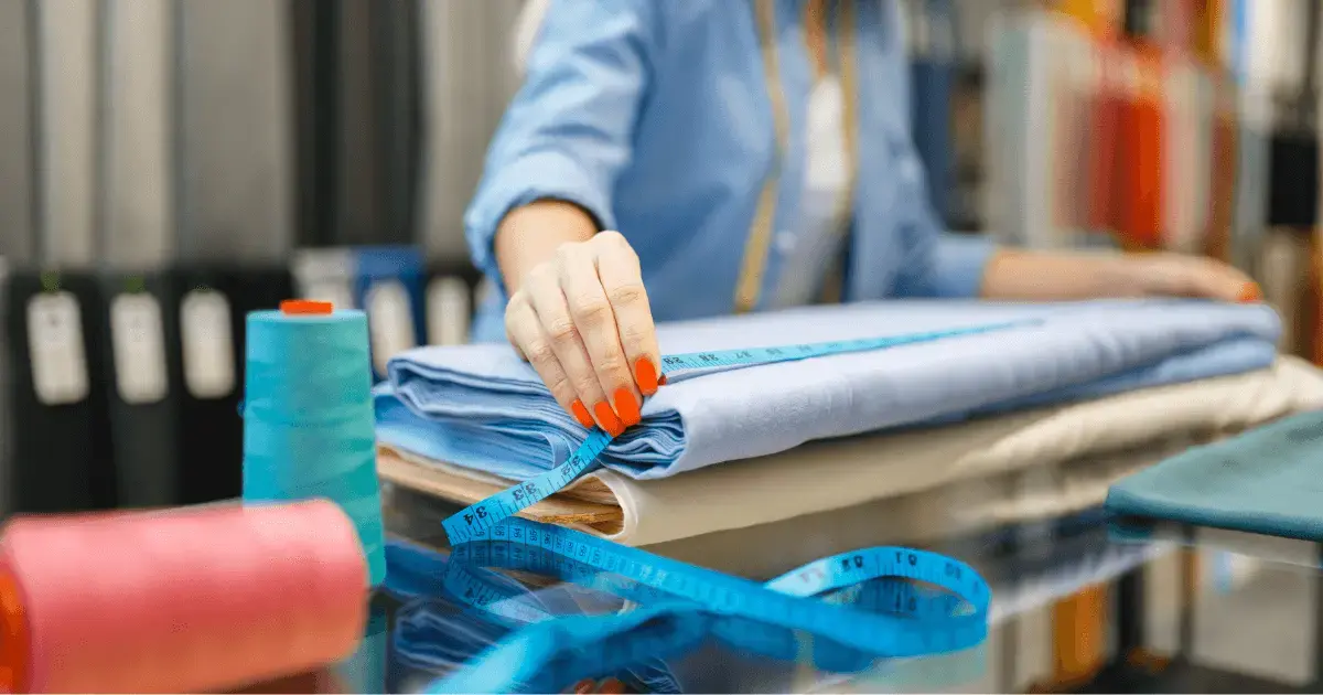 Woman measuring a roll of fabric