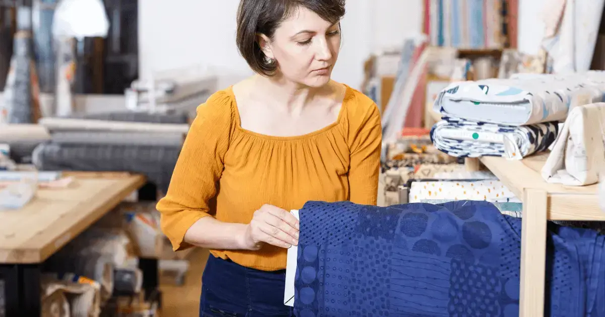 Woman looking for a roll of fabric