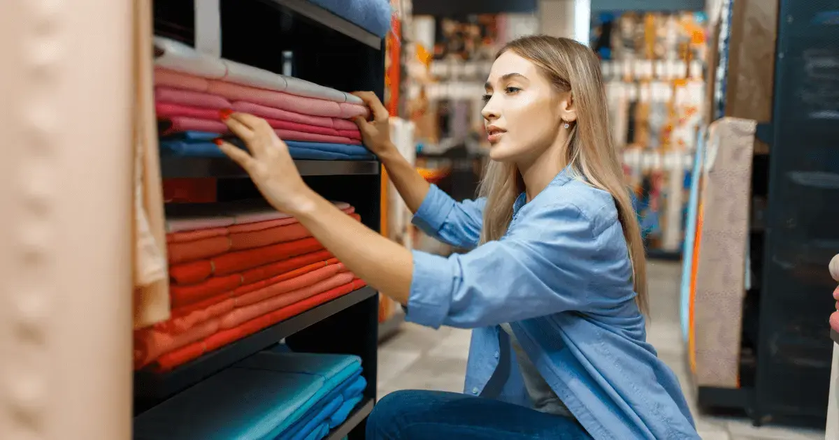 Woman checking the fabric supply at her store