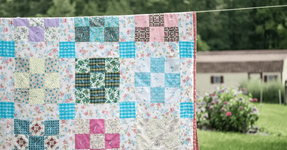 a quilt hanging outside
