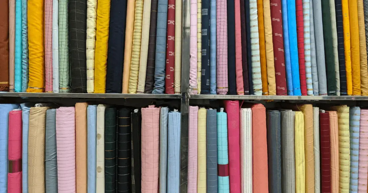 wall of different fabrics in a quilt shop