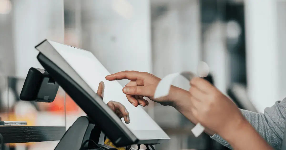 person typing on a pos system