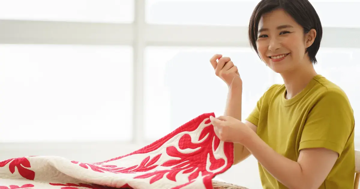 Woman sewing quilt